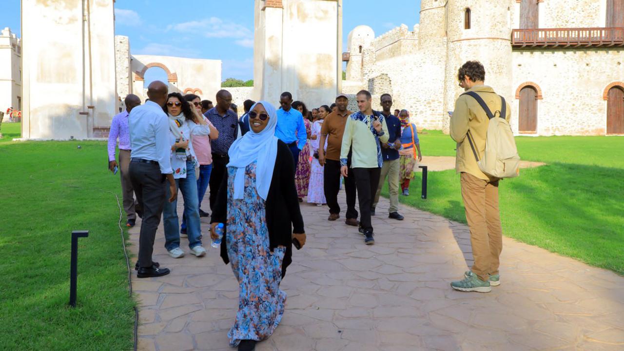 Participants walking together outdoors during the 3is project closing event, in a historic courtyard setting.