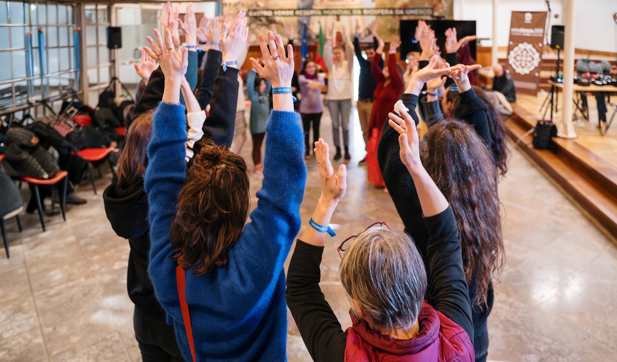 Photo of SoilTribes partners raising hands in the air.